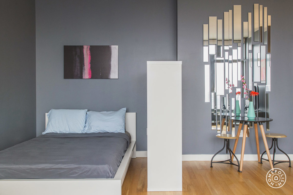 Small minimalist bedroom photo in New York with gray walls