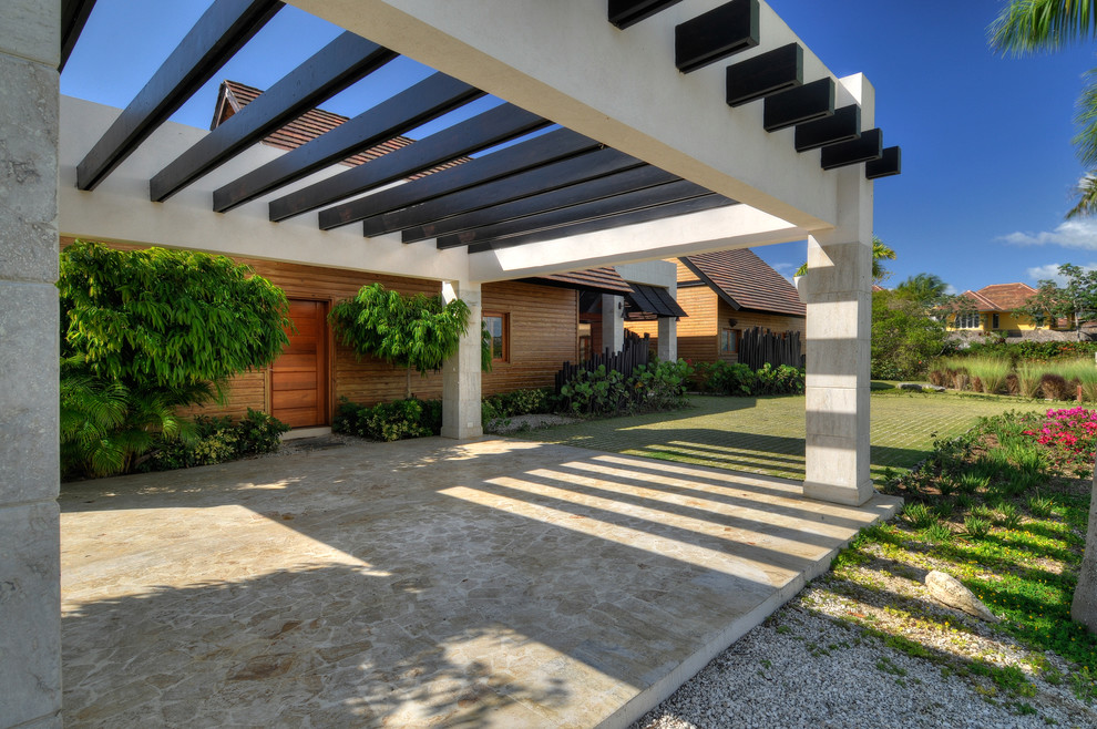Inspiration for a mid-sized tropical detached two-car carport in Other.