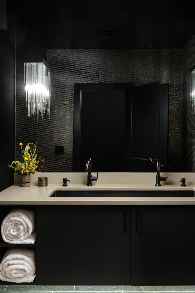 Идея дизайна: ванная комната среднего размера в стиле модернизм с плоскими фасадами, черными фасадами, душем без бортиков, унитазом-моноблоком, черной плиткой, керамической плиткой, черными стенами, полом из цементной плитки, душевой кабиной, врезной раковиной, столешницей из искусственного камня, серым полом, душем с раздвижными дверями, белой столешницей, тумбой под две раковины и подвесной тумбой
