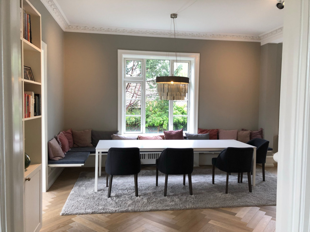 Foto de comedor blanco escandinavo de tamaño medio con con oficina, suelo de madera clara, chimenea lineal, marco de chimenea de baldosas y/o azulejos y paredes grises
