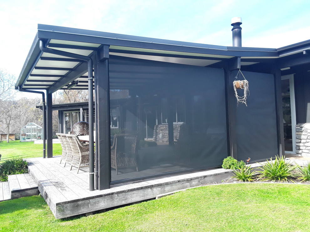 Inspiration for a small country backyard and ground level deck in Napier-Hastings with with privacy feature, a pergola and metal railing.