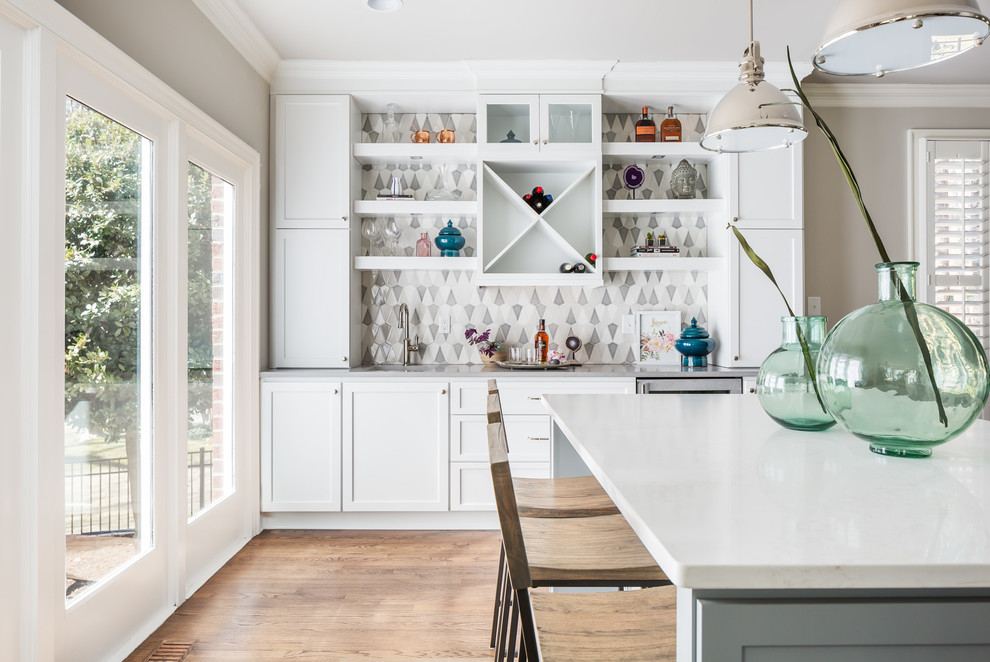 Example of a huge transitional galley medium tone wood floor open concept kitchen design in Raleigh with a farmhouse sink, flat-panel cabinets, white cabinets, quartz countertops, gray backsplash, ceramic backsplash, stainless steel appliances and two islands