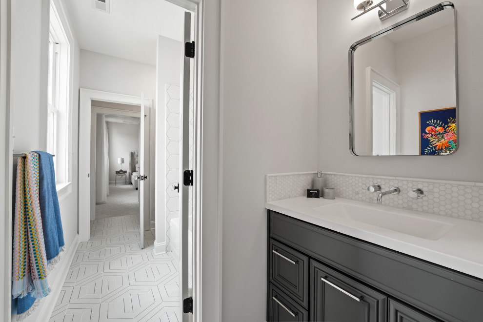 The Cardinal - Mid-sized trendy kids' white tile and ceramic tile ceramic tile, white floor and double-sink alcove bathtub photo in Richmond with beaded inset cabinets, blue cabinets, a one-piece toilet, white walls, an undermount sink, solid surface countertops, white countertops, a niche and a built-in vanity