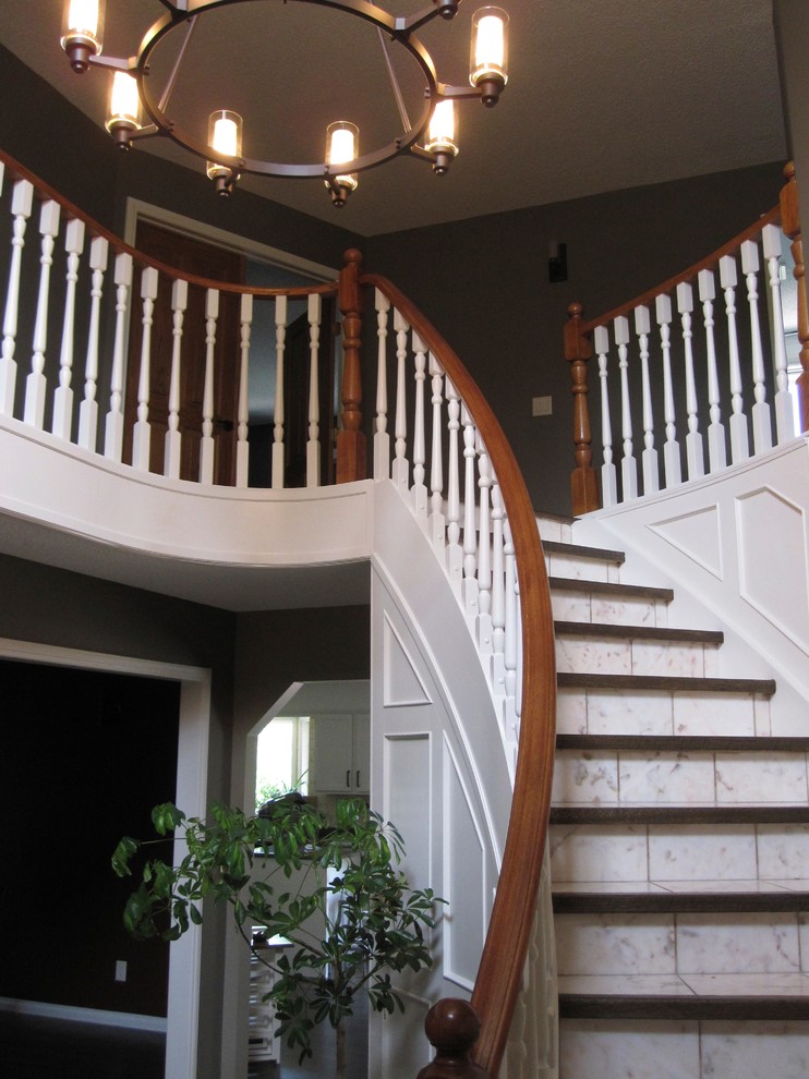 Staircase - large transitional tile curved staircase idea in Calgary with tile risers