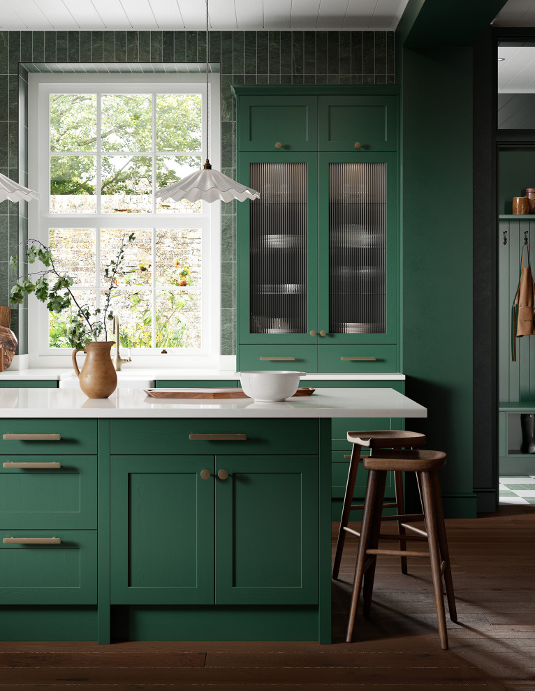 Inspiration for a medium sized traditional l-shaped kitchen/diner in Cheshire with a belfast sink, glass-front cabinets, green cabinets, composite countertops, green splashback, porcelain splashback, medium hardwood flooring, an island, brown floors, white worktops and a timber clad ceiling.