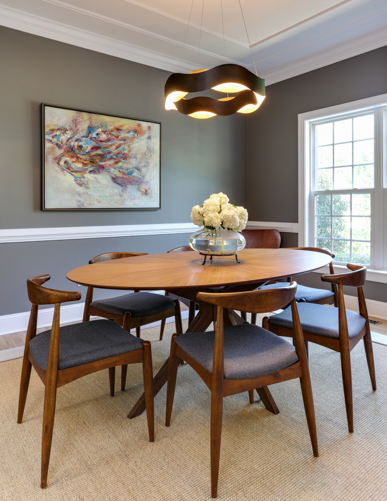 This is an example of a transitional separate dining room in Raleigh with grey walls, medium hardwood floors, no fireplace, brown floor and decorative wall panelling.
