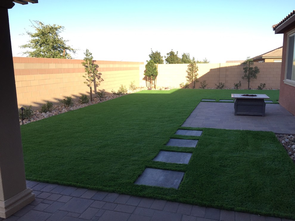 Photo of a mid-sized traditional backyard patio in Las Vegas with a fire feature, brick pavers and no cover.