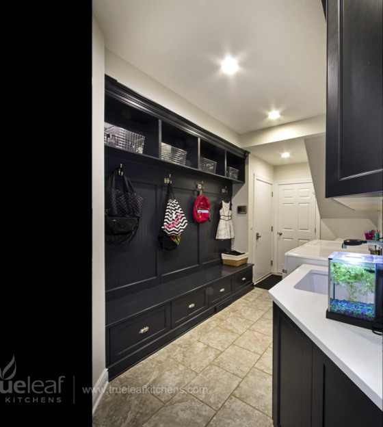 Example of a transitional galley ceramic tile utility room design in New York with a drop-in sink, recessed-panel cabinets, black cabinets, white walls and a side-by-side washer/dryer