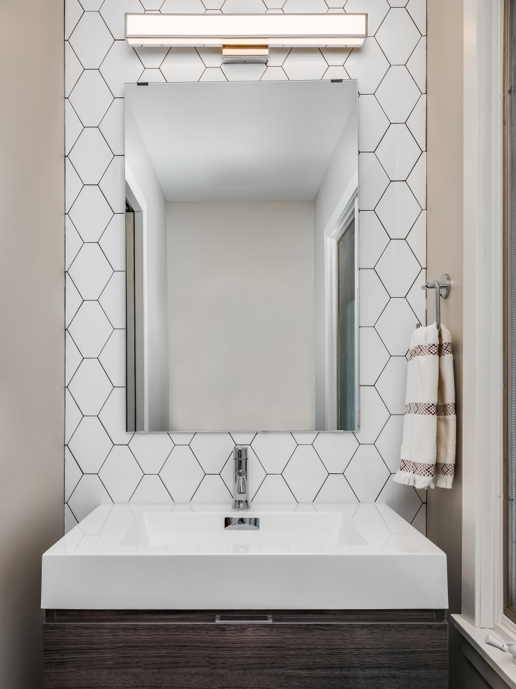 This is an example of a mid-sized midcentury powder room in Minneapolis with flat-panel cabinets, dark wood cabinets, white tile, ceramic tile, white walls, a drop-in sink, engineered quartz benchtops, beige floor, white benchtops and a freestanding vanity.