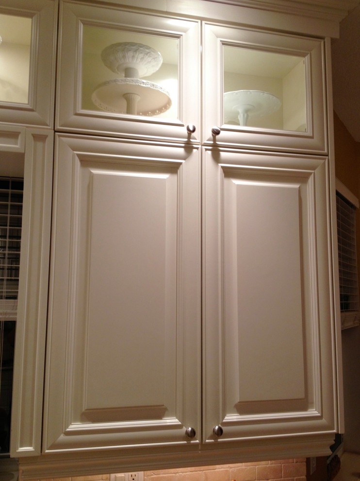 Inspiration for a large transitional u-shaped ceramic tile and beige floor open concept kitchen remodel in Miami with a single-bowl sink, raised-panel cabinets, white cabinets, granite countertops, multicolored backsplash, stone tile backsplash, stainless steel appliances and an island