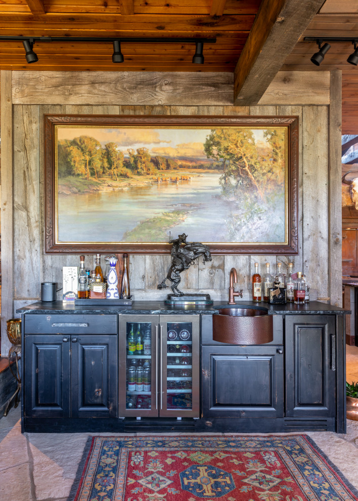 Country single-wall home bar in Denver with raised-panel cabinets, black cabinets, grey floor and black benchtop.