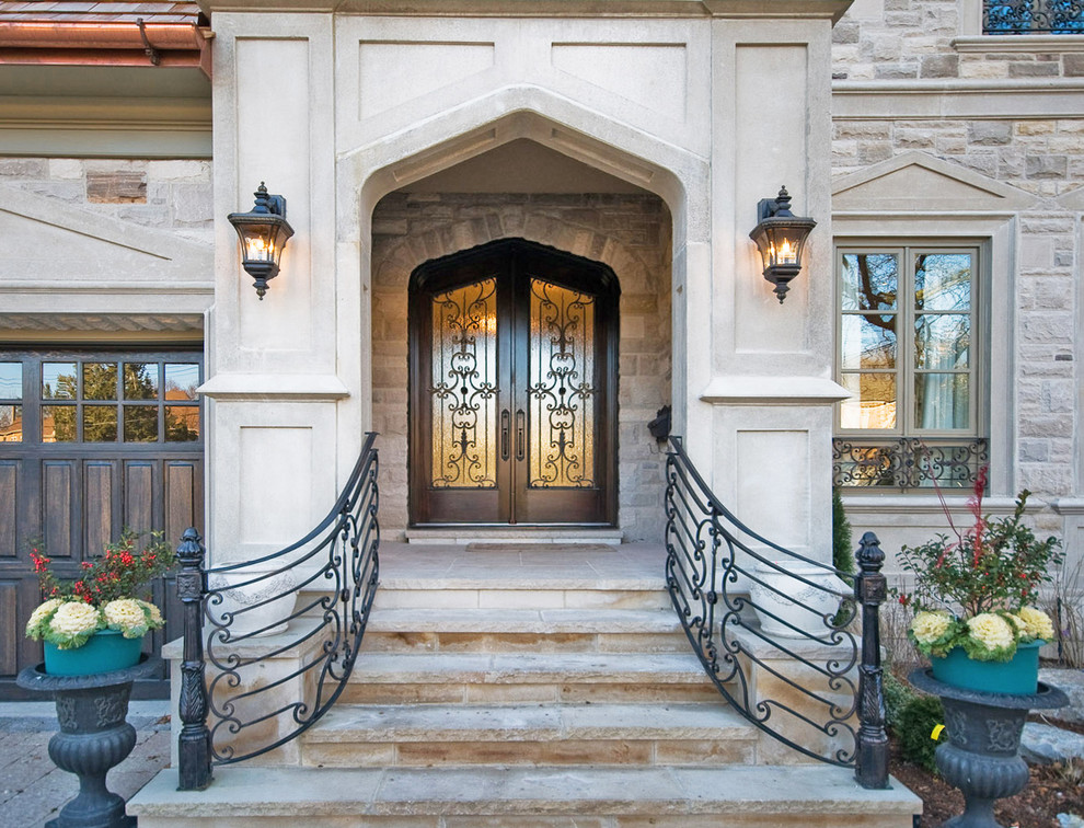 Mid-sized traditional front door in Toronto with beige walls, limestone floors, a double front door, a dark wood front door and beige floor.