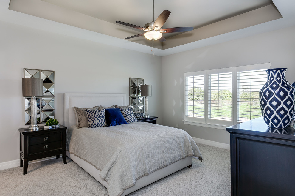 Inspiration for a mid-sized transitional master bedroom in Wichita with beige walls, carpet and beige floor.