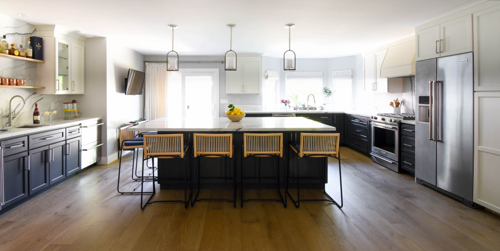 Inspiration for a mid-sized farmhouse u-shaped light wood floor and brown floor open concept kitchen remodel in San Francisco with an undermount sink, shaker cabinets, black cabinets, quartz countertops, white backsplash, ceramic backsplash, stainless steel appliances, an island and white countertops