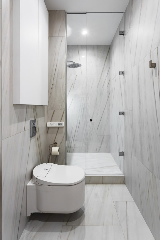 Photo of a small contemporary shower room bathroom in Yekaterinburg with flat-panel cabinets, beige cabinets, an alcove shower, a wall mounted toilet, grey tiles, porcelain tiles, grey walls, porcelain flooring, an integrated sink, engineered stone worktops, grey floors, a hinged door, white worktops, a single sink and a floating vanity unit.