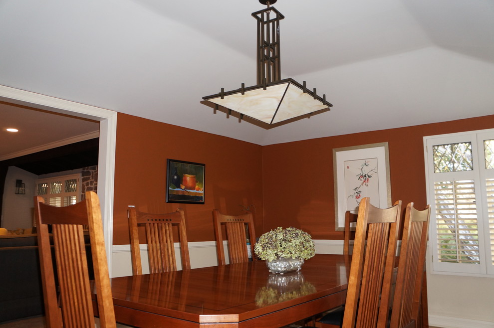 Photo of a transitional separate dining room in Los Angeles with orange walls, medium hardwood floors and no fireplace.