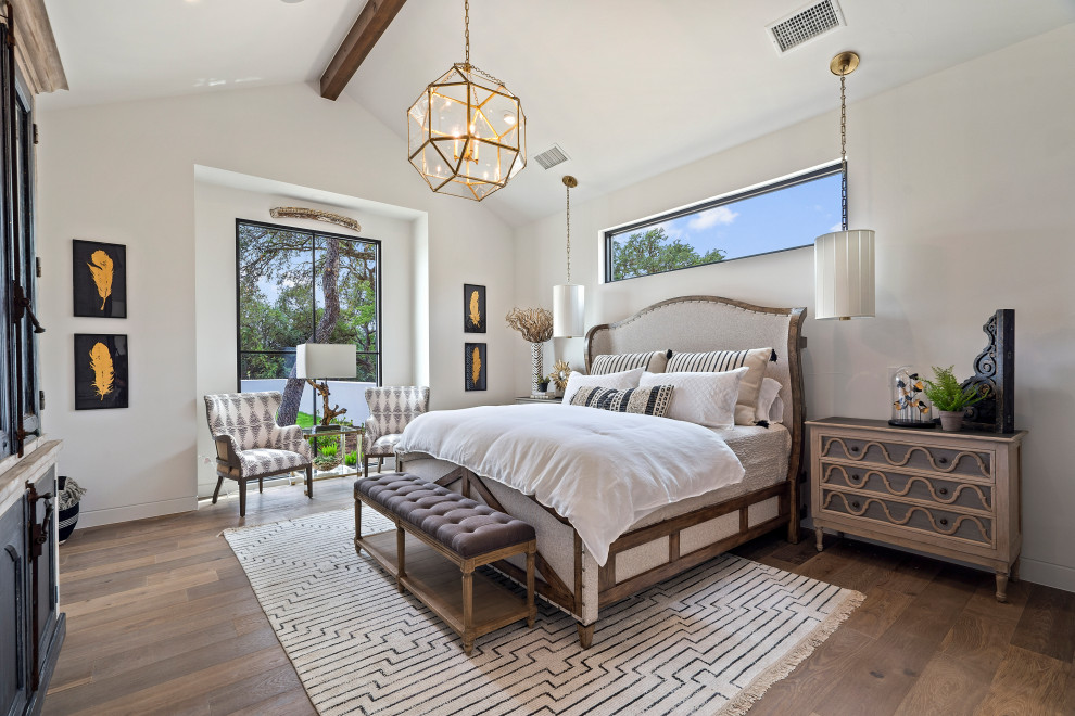 Inspiration for a country bedroom in Austin with grey walls, dark hardwood floors, brown floor, exposed beam and vaulted.