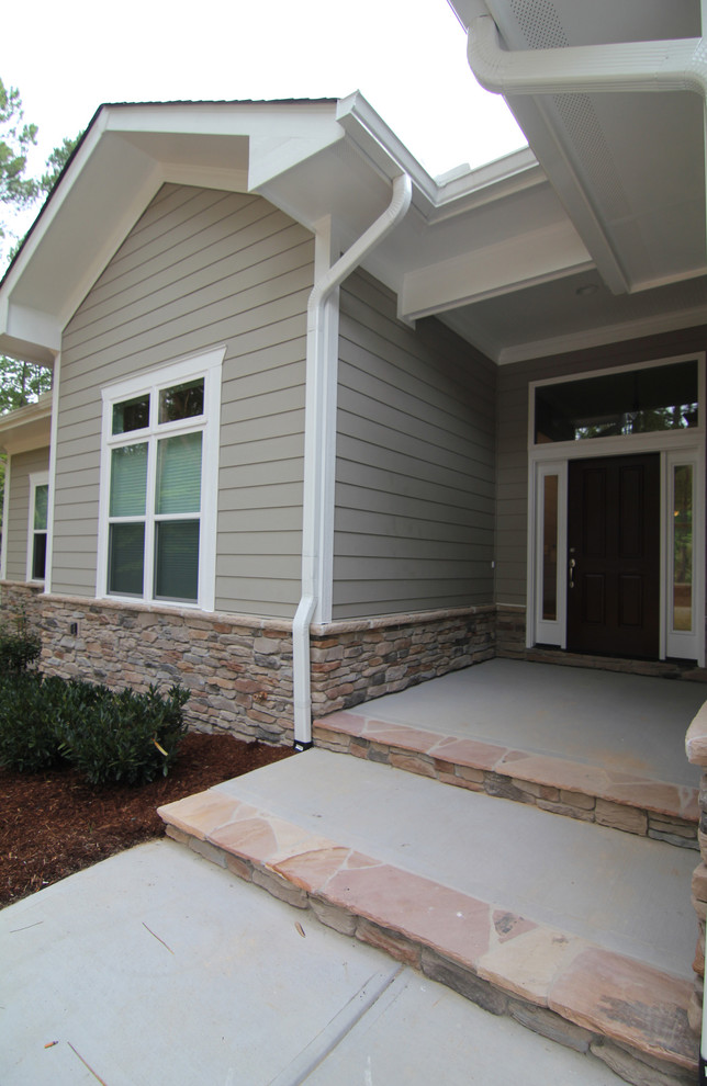 Front door - mid-sized transitional front door idea in Raleigh with a dark wood front door