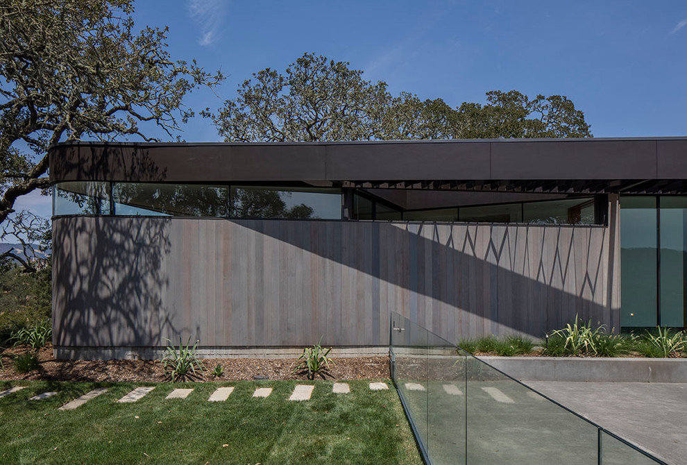 Inspiration for a large modern one-storey grey house exterior in San Francisco with wood siding.