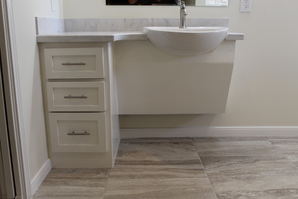 Inspiration for a mid-sized transitional bathroom in Houston with shaker cabinets, white cabinets, an open shower, a one-piece toilet, beige tile, porcelain tile, beige walls, porcelain floors, a vessel sink, beige floor, an open shower and beige benchtops.