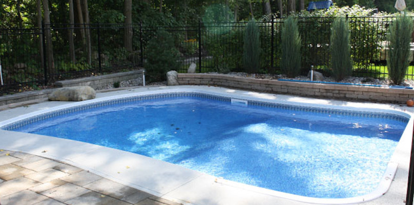 Mid-sized backyard stamped concrete and rectangular pool photo