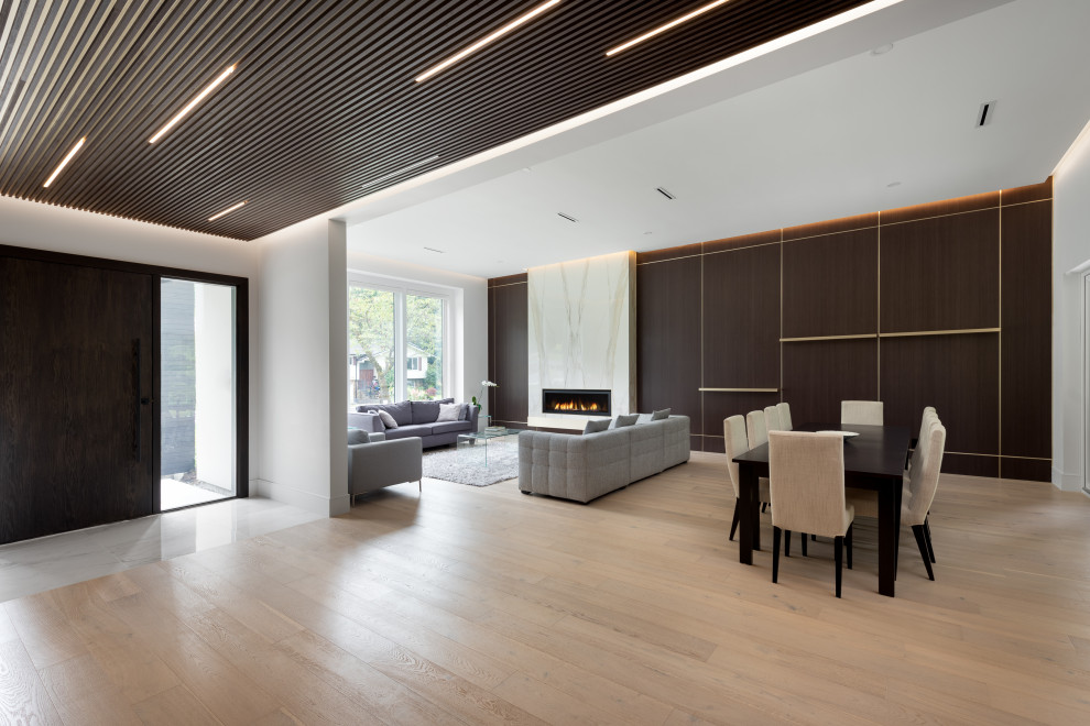 Inspiration for a large contemporary foyer in Vancouver with white walls, medium hardwood floors, wood and wood walls.