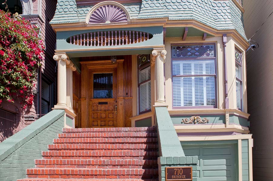 Large traditional three-storey multi-coloured exterior in San Francisco with wood siding and a gable roof.