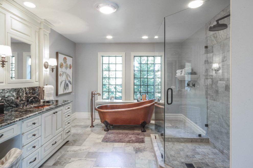 Design ideas for a large traditional master bathroom in Detroit with raised-panel cabinets, distressed cabinets, a claw-foot tub, grey walls, porcelain floors, an undermount sink, engineered quartz benchtops, grey floor, a hinged shower door, black benchtops, a corner shower and gray tile.