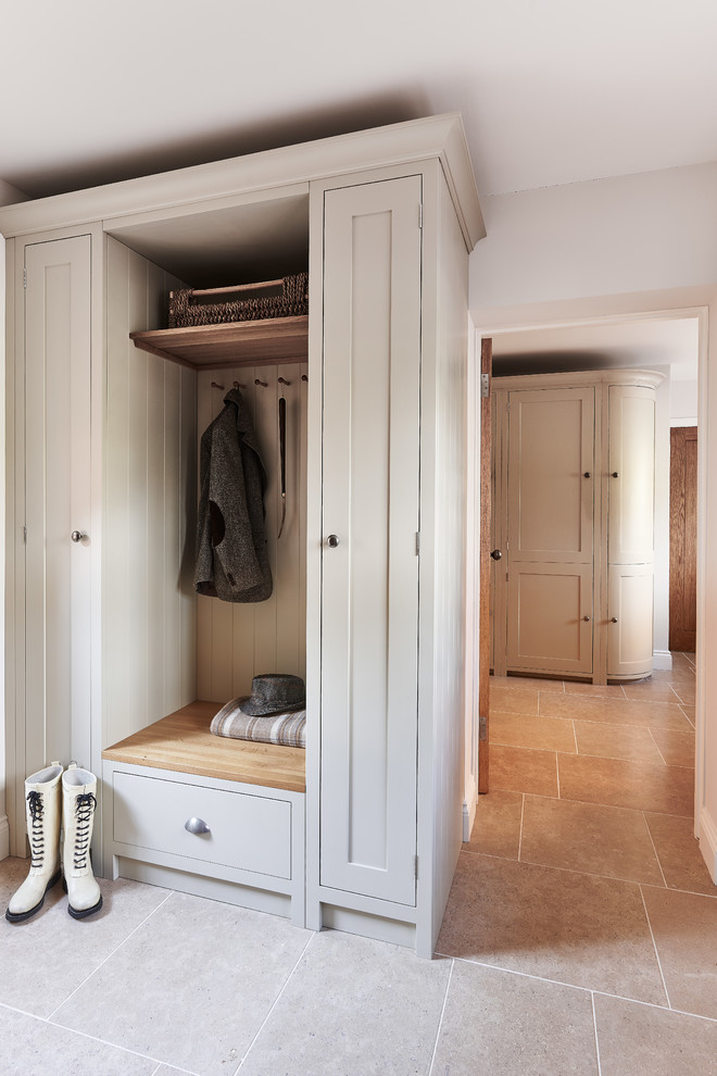 Inspiration for a small traditional mudroom in Berkshire with white walls and limestone floors.