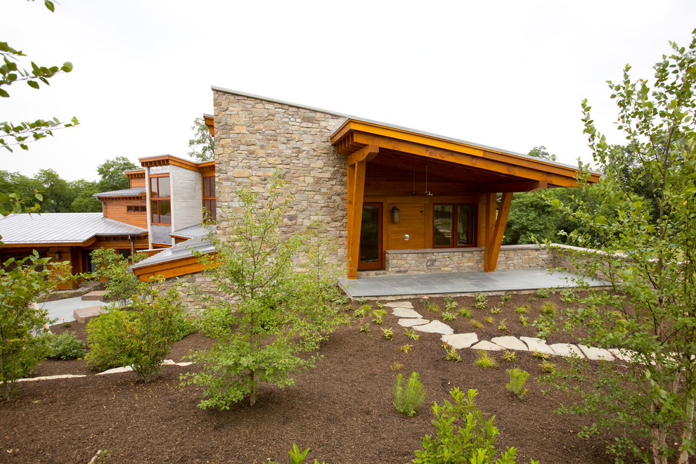 Photo of a contemporary two-storey brown exterior in Philadelphia with stone veneer.