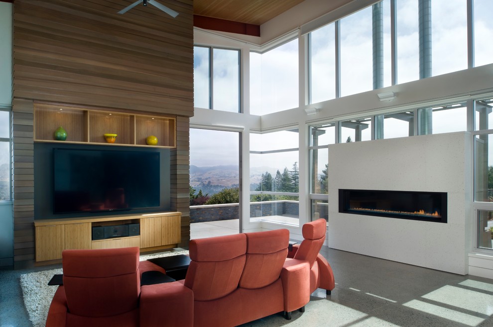 Contemporary family room in San Francisco with concrete floors, a ribbon fireplace and a wall-mounted tv.