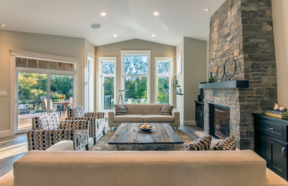 Mid-sized transitional open concept living room in Toronto with grey walls, dark hardwood floors, a standard fireplace and a stone fireplace surround.