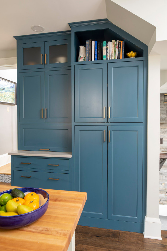 Mid-sized country galley kitchen pantry in Minneapolis with blue cabinets, ceramic splashback, vinyl floors, brown floor and white benchtop.