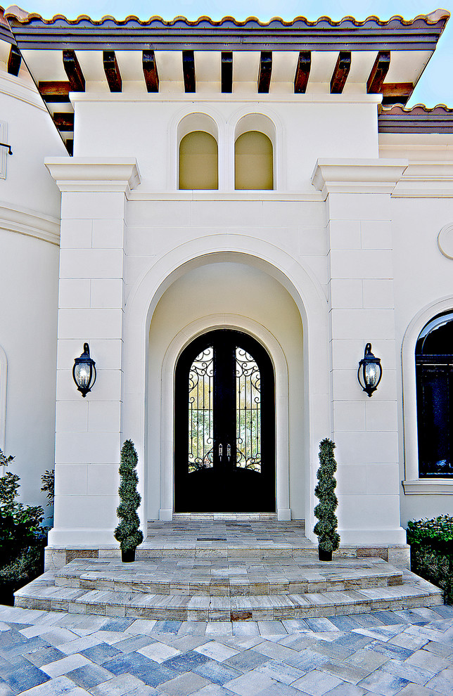Expansive mediterranean one-storey stucco white exterior in Miami with a hip roof.