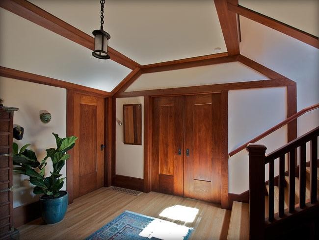 Inspiration for a large traditional foyer in San Francisco with white walls, light hardwood floors, a single front door and a medium wood front door.