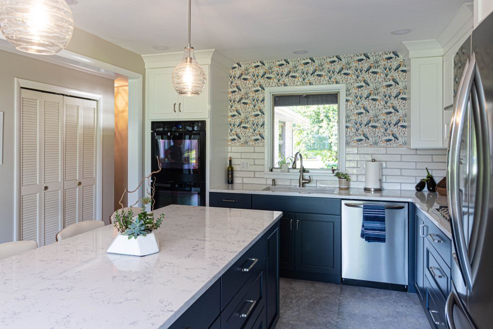 Eat-in kitchen - mid-sized transitional l-shaped porcelain tile and gray floor eat-in kitchen idea with an undermount sink, flat-panel cabinets, white cabinets, quartz countertops, white backsplash, subway tile backsplash, stainless steel appliances, an island and white countertops