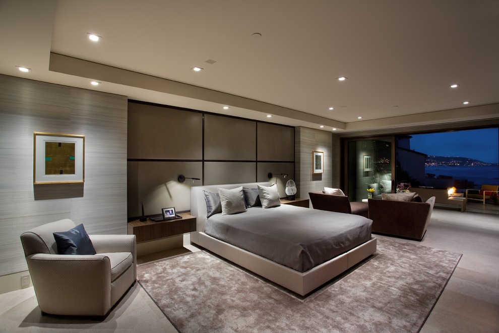 Design ideas for an expansive modern master bedroom in Orange County with grey walls, limestone floors and beige floor.