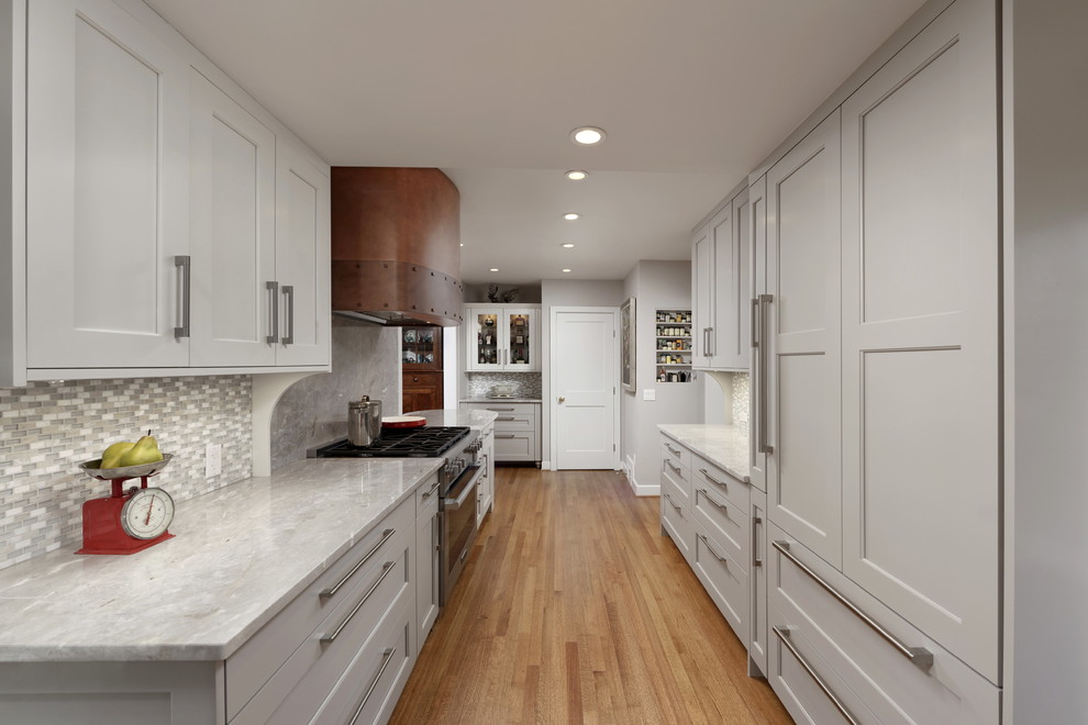 Design ideas for a large transitional galley eat-in kitchen in DC Metro with an undermount sink, shaker cabinets, grey cabinets, quartzite benchtops, grey splashback, mosaic tile splashback, stainless steel appliances, medium hardwood floors, a peninsula, brown floor and grey benchtop.