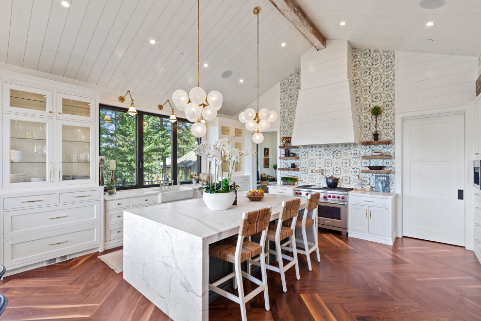 Photo of a traditional kitchen/diner in Other with a belfast sink, an island, a timber clad ceiling, exposed beams, a vaulted ceiling, shaker cabinets, white cabinets, marble worktops, multi-coloured splashback, medium hardwood flooring, brown floors and multicoloured worktops.