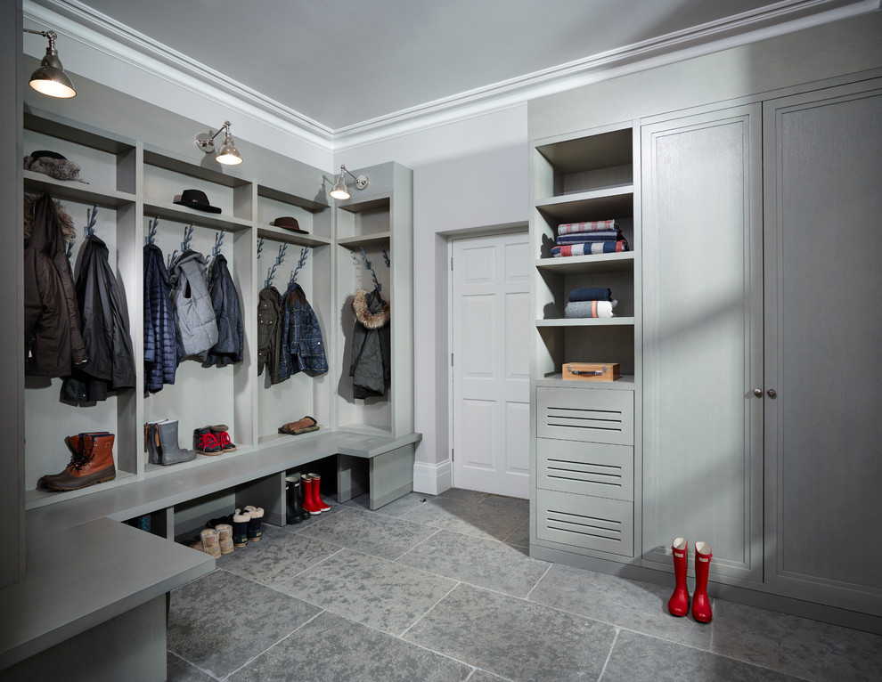 Design ideas for a transitional mudroom in London with grey walls and limestone floors.
