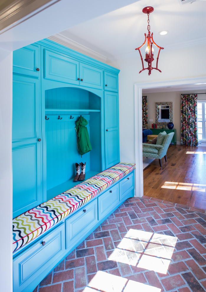 Design ideas for a traditional mudroom in Atlanta with brick floors and red floor.