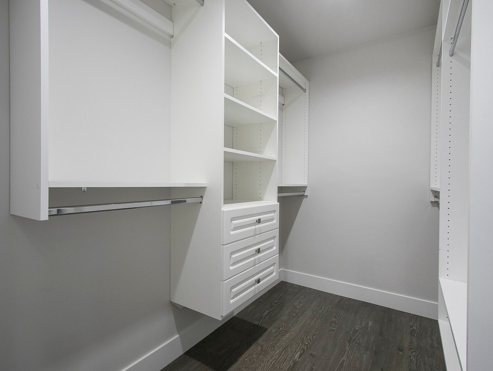 This is an example of a small contemporary walk-in wardrobe in Vancouver with open cabinets, white cabinets and dark hardwood floors.