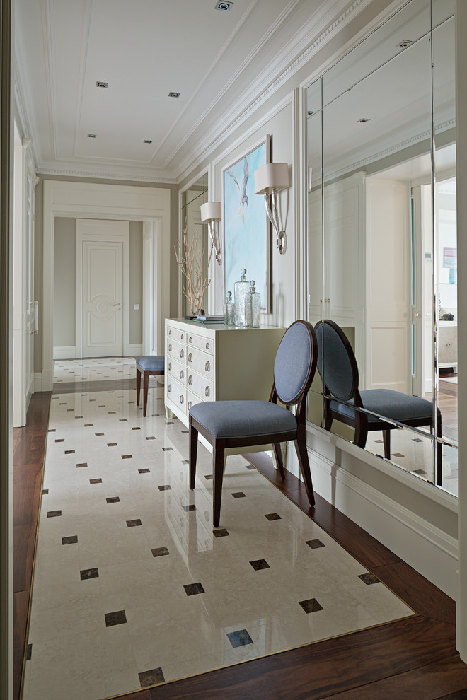 Inspiration for a transitional entryway in Moscow with beige walls and marble floors.
