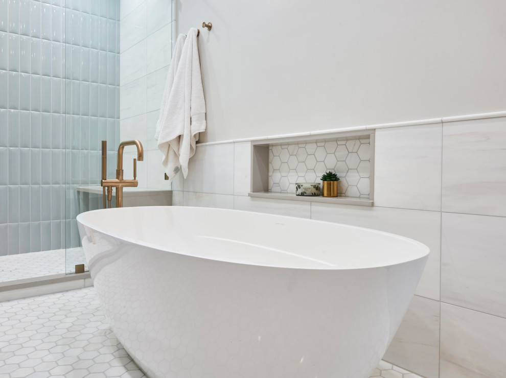 Photo of a mid-sized transitional master bathroom in Chicago with flat-panel cabinets, medium wood cabinets, a freestanding tub, an alcove shower, white tile, porcelain tile, white walls, porcelain floors, an undermount sink, quartzite benchtops, white floor, a hinged shower door, white benchtops, a shower seat, a double vanity and a freestanding vanity.