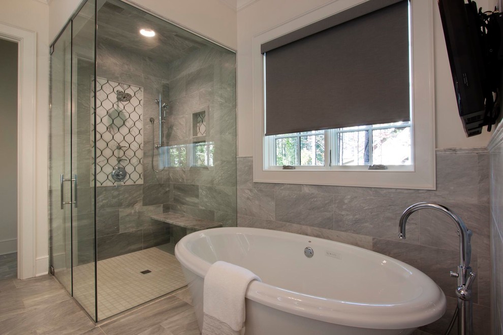 Photo of a large transitional master bathroom in Other with brown cabinets, a freestanding tub, gray tile, marble, marble floors, marble benchtops, grey floor, shaker cabinets, white walls, a hinged shower door, a curbless shower, a two-piece toilet and an undermount sink.