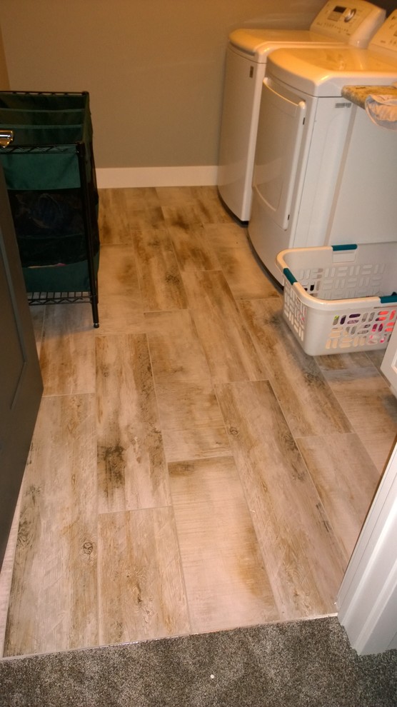 Example of a mid-sized mountain style porcelain tile dedicated laundry room design with gray walls and a side-by-side washer/dryer