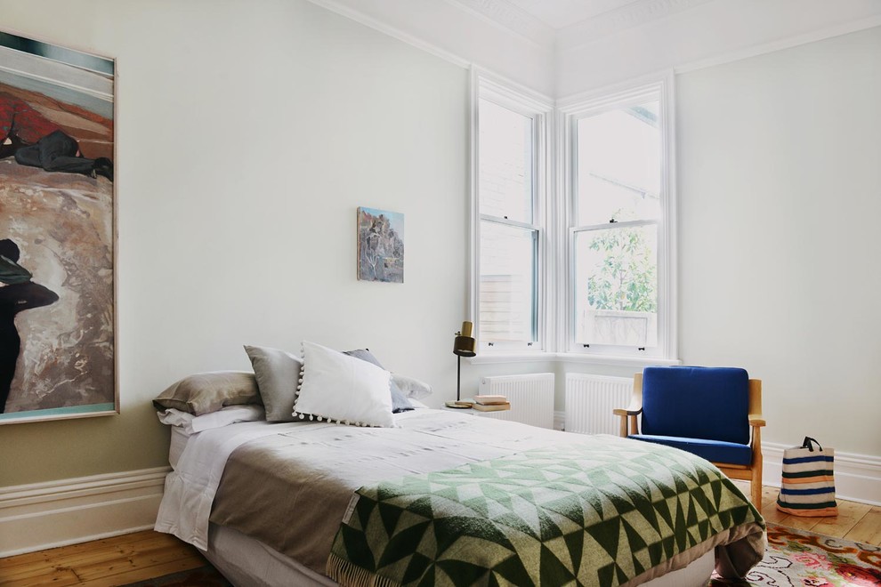Photo of a mid-sized contemporary master bedroom in Melbourne with green walls, light hardwood floors and no fireplace.