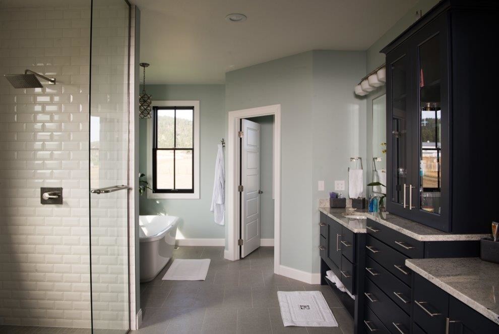 Design ideas for a mid-sized country master bathroom in Other with recessed-panel cabinets, black cabinets, a freestanding tub, an open shower, white tile, subway tile, grey walls, porcelain floors, an undermount sink, granite benchtops, grey floor and a shower curtain.