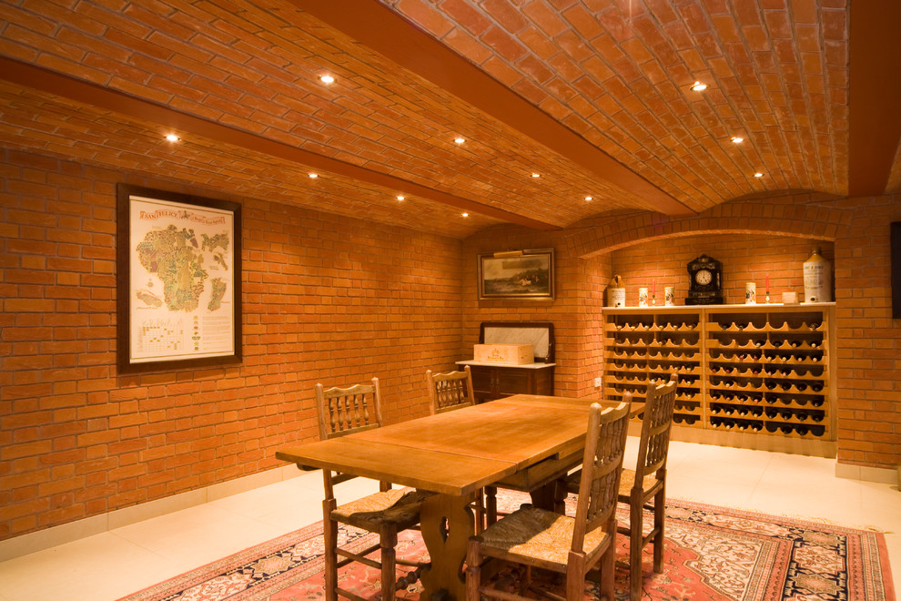 This is an example of a mid-sized country wine cellar in Other with storage racks.