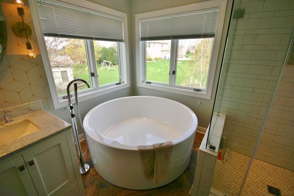 Design ideas for a large contemporary master bathroom in Milwaukee with an undermount sink, recessed-panel cabinets, white cabinets, granite benchtops, a corner tub, a corner shower, a two-piece toilet, white tile, ceramic tile, beige walls and ceramic floors.